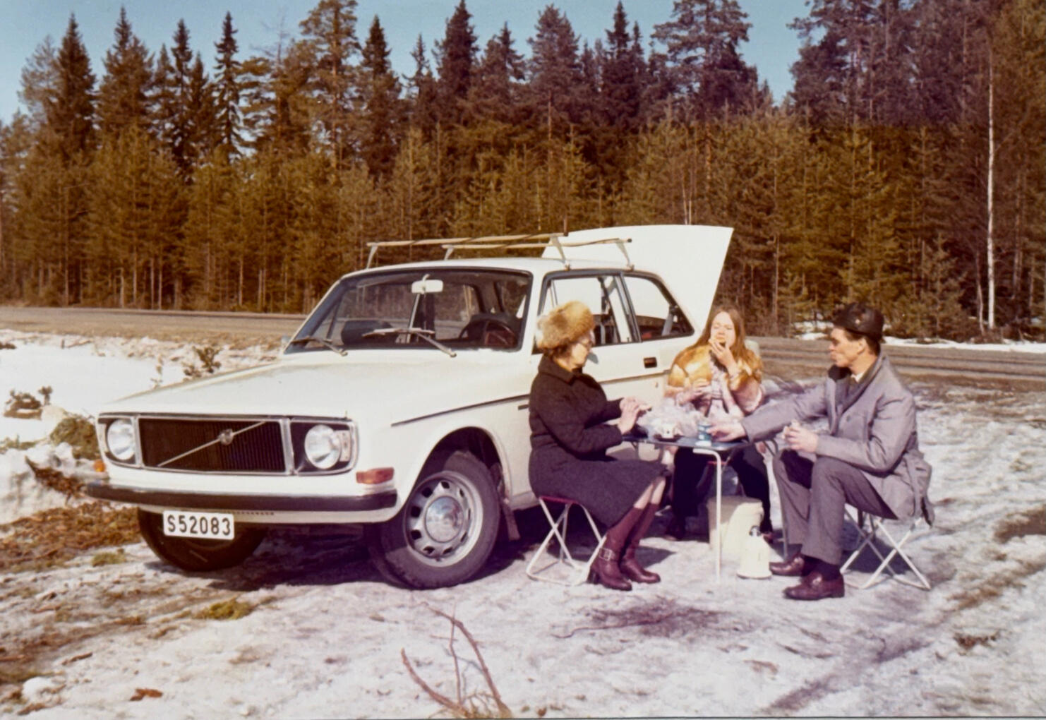 A winter coffee break - my grandparents and mother with their Volvo 142.