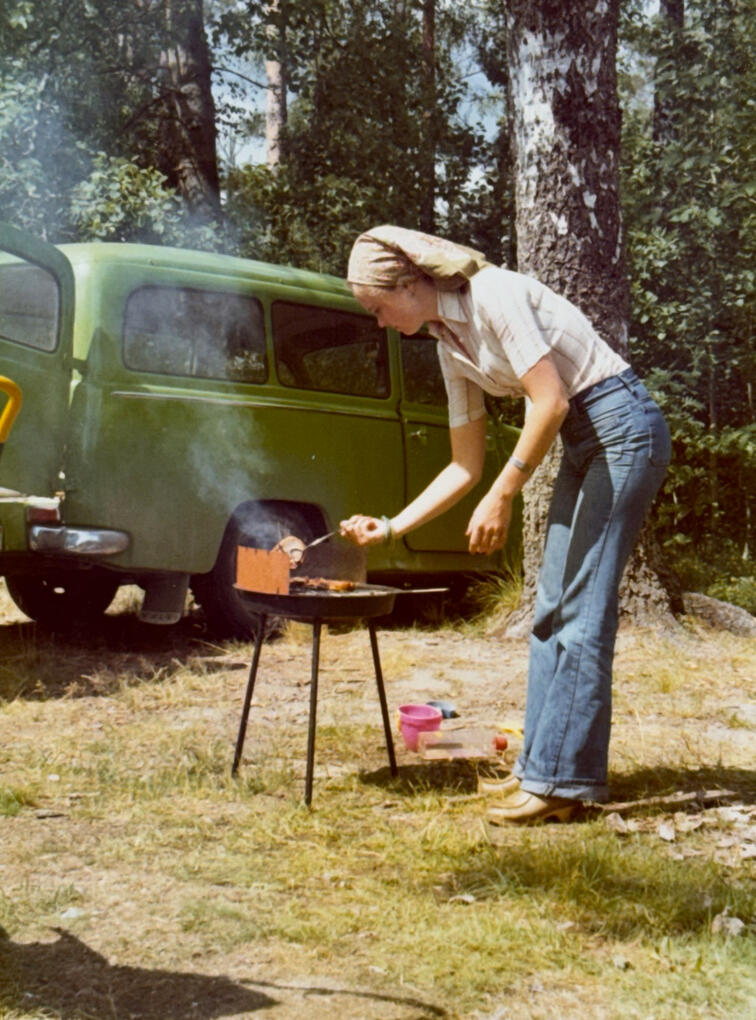 A classic 1970s camping scene with a Volvo Duett in the background.